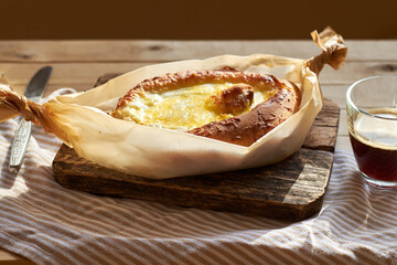 Adjaruli (Acharuli) Khachapuri, Georgian cheese bread. Traditional Georgian recipe made with a bread dough, filled with cheese and crowned with an egg and a butter. 