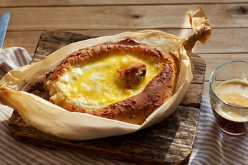 Adjaruli (Acharuli) Khachapuri, Georgian cheese bread. Traditional Georgian recipe made with a bread dough, filled with cheese and crowned with an egg and a butter. 