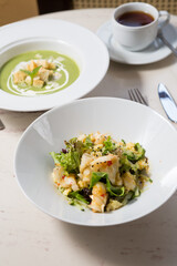 Shrimp salad on a white marble cafe table