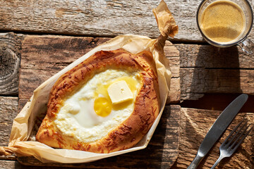 Adjaruli (Acharuli) Khachapuri, Georgian cheese bread. Traditional Georgian recipe made with a bread dough, filled with cheese and crowned with an egg and a butter. 