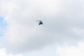 Fototapeta na wymiar A German police helicopter in flight during an operation in the state of Baden-Wurttemberg.