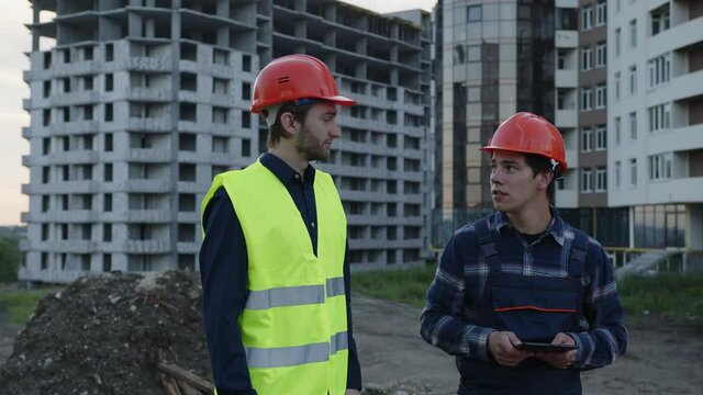 Men discuss their house project together