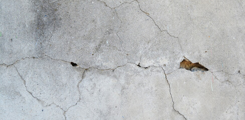 Crack wall texture. Cracked concrete wall covered with cement surface as background. Wall fragment...