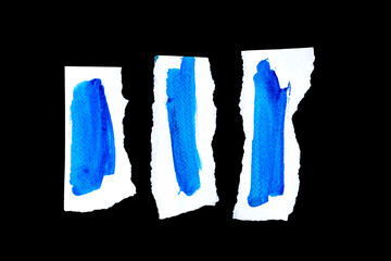 Recycled paper craft stick on a black background, Blue paint paper torn or ripped pieces of close up blue paper isolated on black background with clipping path.