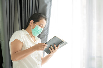 Religious woman in protective face mask and praying to God
