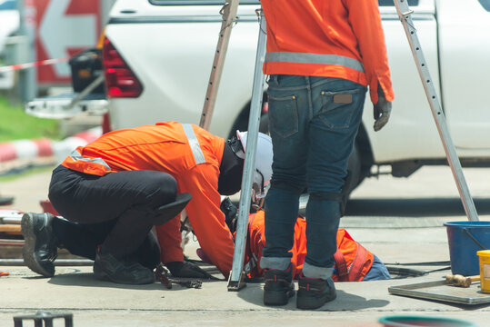 South East Asian, People, Technicians Clean Up Oil Spill And Repairs Damaged Fuel Pump.