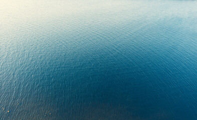Fototapeta na wymiar Aerial view of a crystal clear sea water texture. Top view from above. Natural blue background. Blue water reflection. Blue ocean wave. Summer sea. Drone. Top view