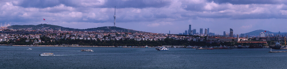 Fototapeta premium Panoramic view of Istanbul showing Grand Çamlıca Mosque in Üsküdar and tallest flag in Istanbul and Istanbul Skyscrapers and the Water Transport in Istanbul on the Bosporus.