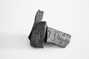 Pile of black charcoal on a white