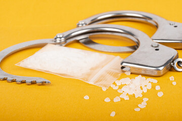 handcuffs and crystals of drugs, arrest of a drug dealer