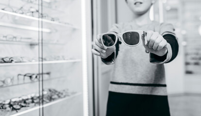 Close-up portrait of little kid boy with eyeglasses. Happy smiling child in casual clothes....