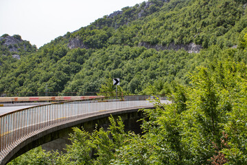 Fototapeta na wymiar Winding and picturesque road high in the mountains. Beautiful summer landscape. Transport route and nature.