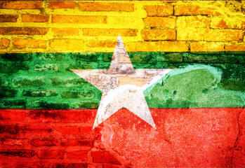 Myanmar national flag on brick wall.