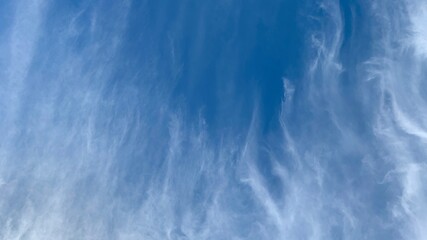 Bright blue sky background with white abstract clouds Cirrus, Cirrus uncinus, Cirrus Kelvin-Helmholtz and curved space for text  clouds  flowing
