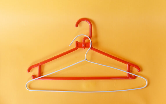Clooth hanger in red and white color on yellow background