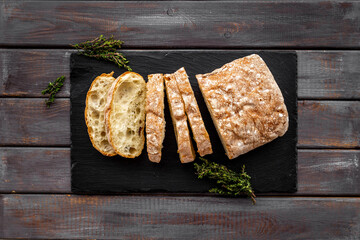 Sliced bread ciabatta with rosemary. Breakfast background