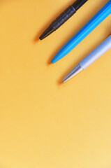 Colorful pens on yellow color background,education and background concept