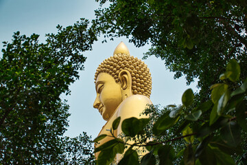 Giant golden buddha statue of Dhammakaya Thep Mongkol Buddha in construction site located at Wat...