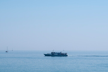 the ship is moving along the horizon of the sea