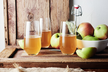 Three glasses of apple drink, cider.