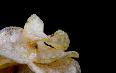 Potato chips on a black background. crispy potato chips.