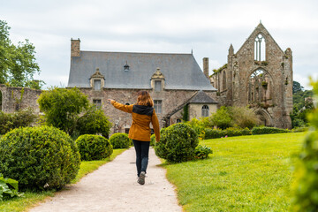 A young tourist visiting Abbaye de Beauport in the village of Paimpol, Côtes-d'Armor department,...
