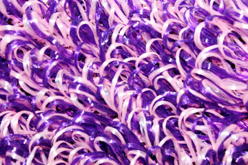 purple and white washcloth close-up. The view from the top. Texture. Background. Abstraction. Knitted washcloth. Self-care. The washcloth is made of propylene thread