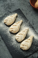 Frozen khinkali on stone background. National georgian food.
