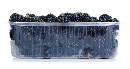 Plastic container with blackberries on white background isolation