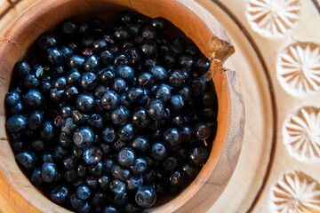 Useful and very tasty blueberries are collected high in the mountains. Dark blue whortleberry in a...