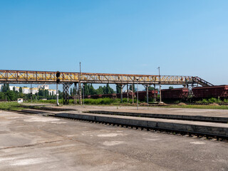 Railroad station. Long iron footbridge across the railroad tracks.