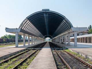 Fototapeta premium Empty train station. A platform under a glass roof.