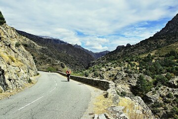 Corsica-cyclist on the way along the river Golo