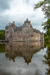 Obraz premium Reflections of the medieval Chateau Trecesson in the lake, Campénéac commune in the Morbihan department, near the Broceliande forest.