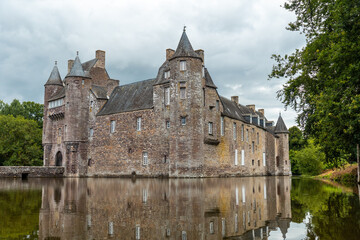 Fototapeta na wymiar Reflections of the medieval Chateau Trecesson in the lake, Campénéac commune in the Morbihan department, near the Broceliande forest.