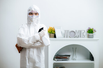 Fototapeta premium Disinfection specialist in PPE suit performing public decontamination
