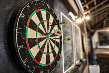 Closeup of dartboard with arrows on the target