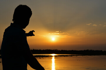 Fototapeta premium Sunrise and sunset with a person.