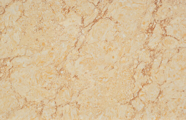 Texture of yellow and orange marble. Stone tile with natural pattern. Marble pavement closeup.