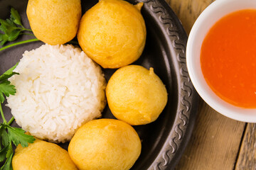 Chinese chicken balls with rice and sweet sauce on the table