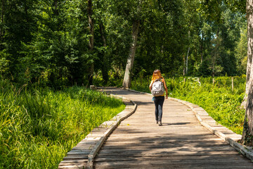 A young woman on the footpath along a footbridge between La Garette and Coulon, Marais Poitevin the...