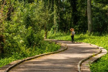 A young woman walking on the trek on the trail between La Garette and Coulon, Marais Poitevin the...