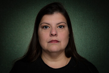 Closeup of a woman with serious expression in a studio headshot