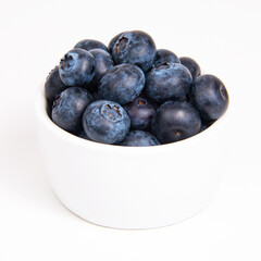 Fresh blueberry in white dish on the white background