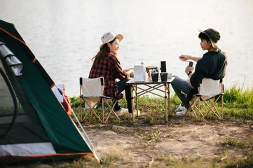 Wall murals Camping Cheerful Young Couples camping with morning coffee.