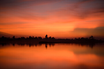 Fototapeta na wymiar The beautiful nature with golden lake in sunset