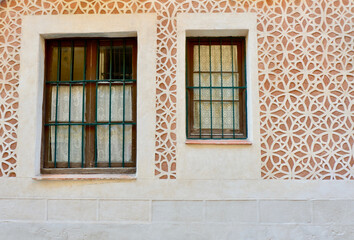 Fototapeta premium Two different windows on the wall with sgraffito finishing technique, typical in Segovia downtown district, Spain