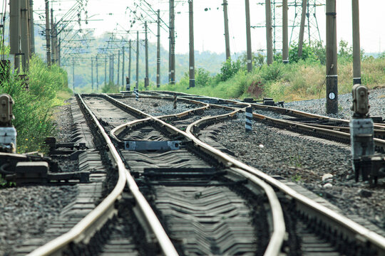 Railroad crossing at the marshaling yard in cloudy weather. Railroad junction on a double track road