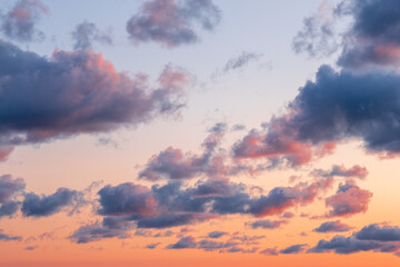 Naklejka na ściany i meble Orange - blue clouds during sunset. Beautiful, colorful dramatic sky background. Scene view