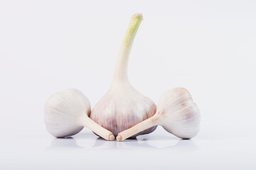 Garlic on a white isolated background. Head of young garlic. 